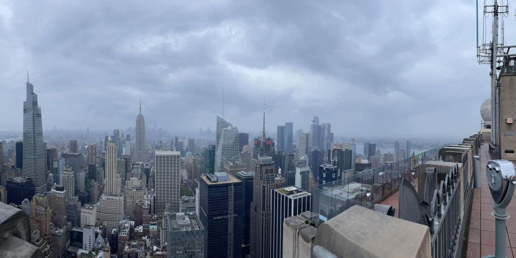 View from the Top of the Rocks building looking out onto a cloudy New York City